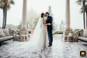 Villa Montalbano's Liberty-style front porch in Varese, Italy, frames a sweet, intimate moment captured between the newlyweds.